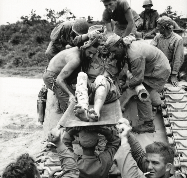Private W.D. Fuhlrodt is removed from tank that carried him from front lines because Japanese artillery and small arms fire made it impossiblefor ambulances to carry wounded to safety, Okinawa, 1945 (Alpha Stock/Alamy)